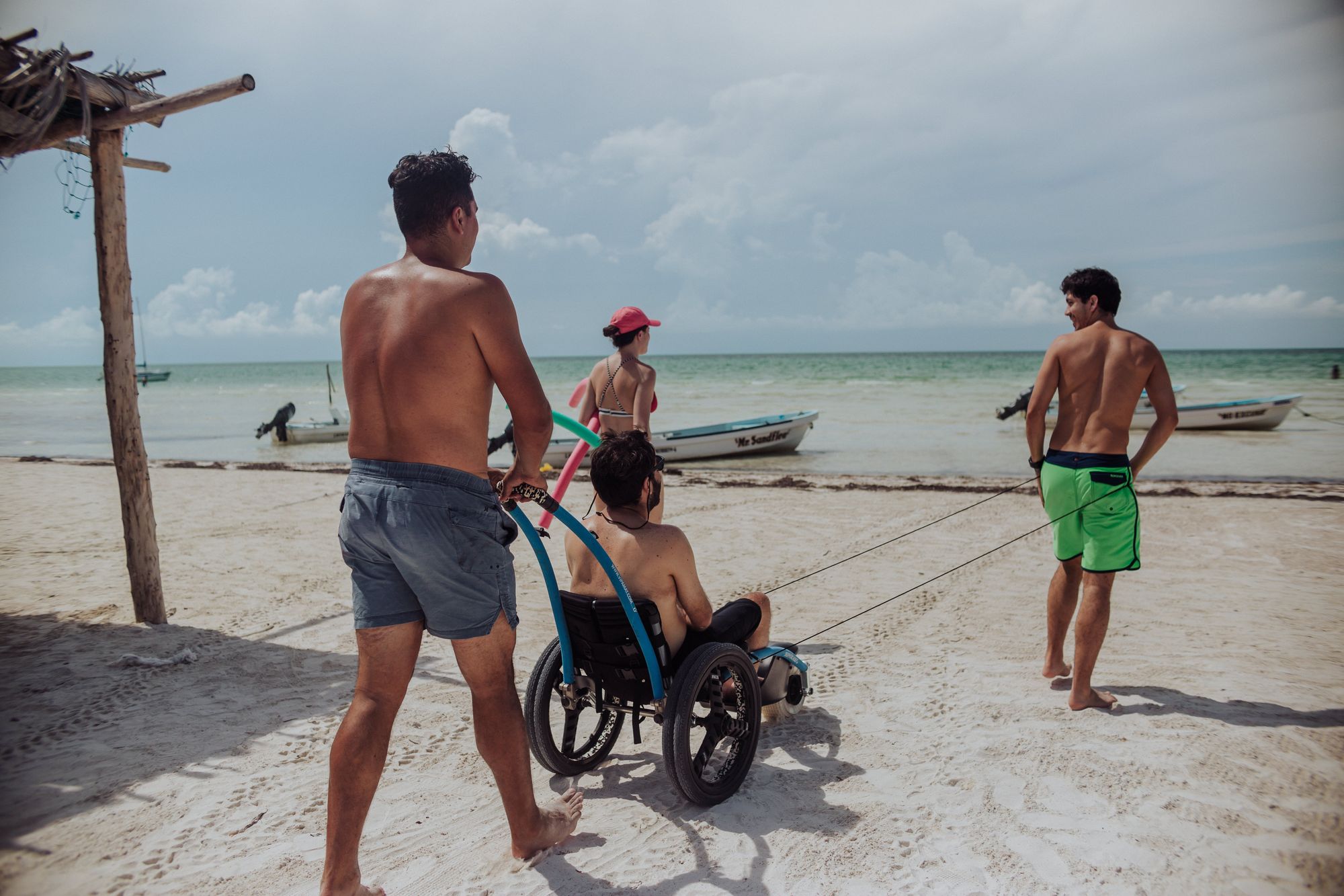 Wheelchair user entering the ocean in Cancun