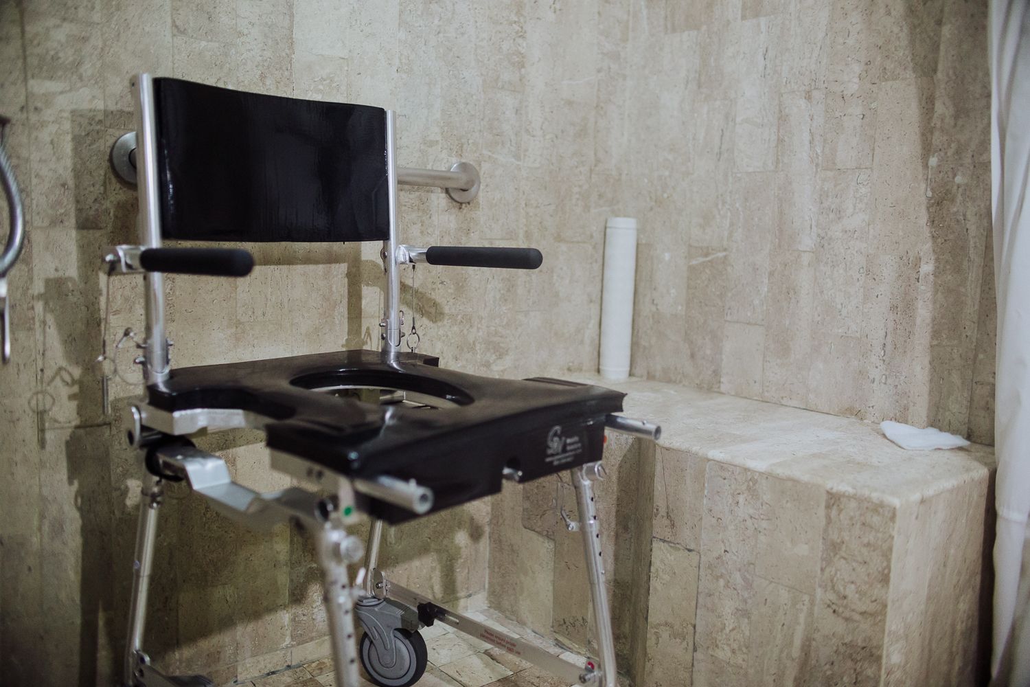 An accessible shower seat in a roll-in shower