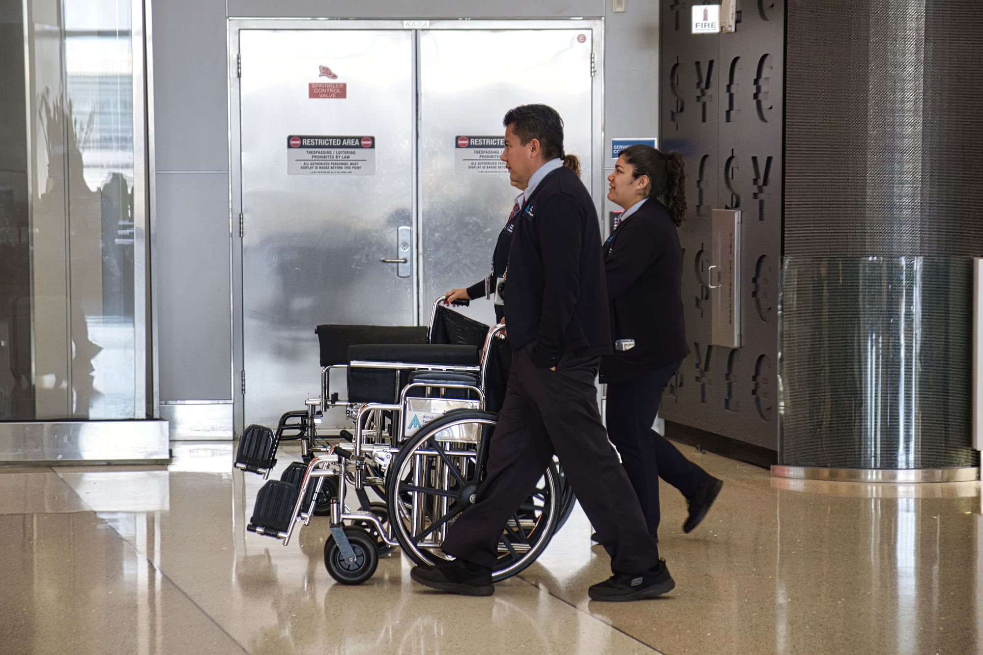 Wheelchair attendants assist disabled people at the airport