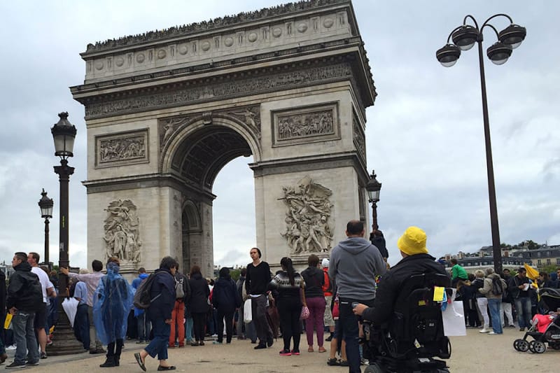 Wheelchair user viewing the Arc de Triomphe, an accessible attraction in Paris