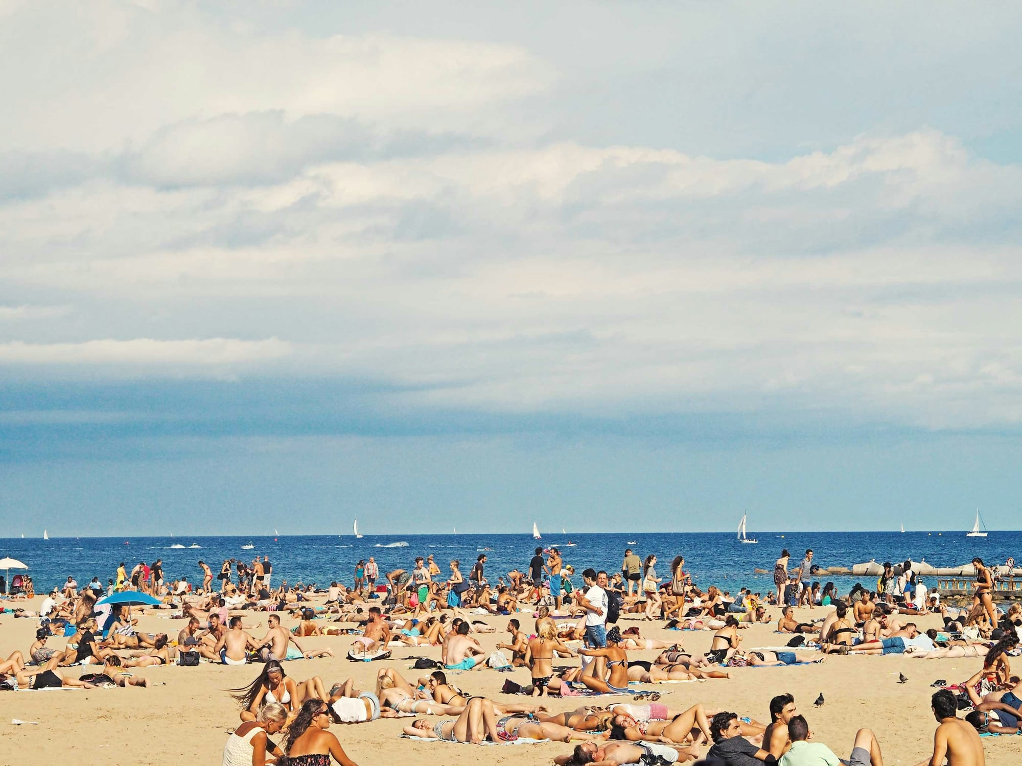 People relaxing on one of Barcelona's sandy beaches
