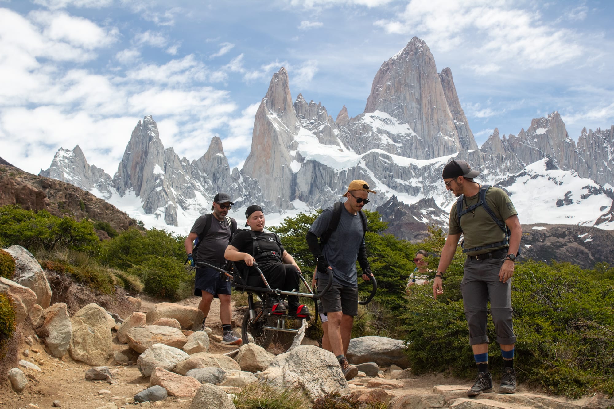 A wheelchair users hiking through Patagonia in a joelette wheelchair with assistance