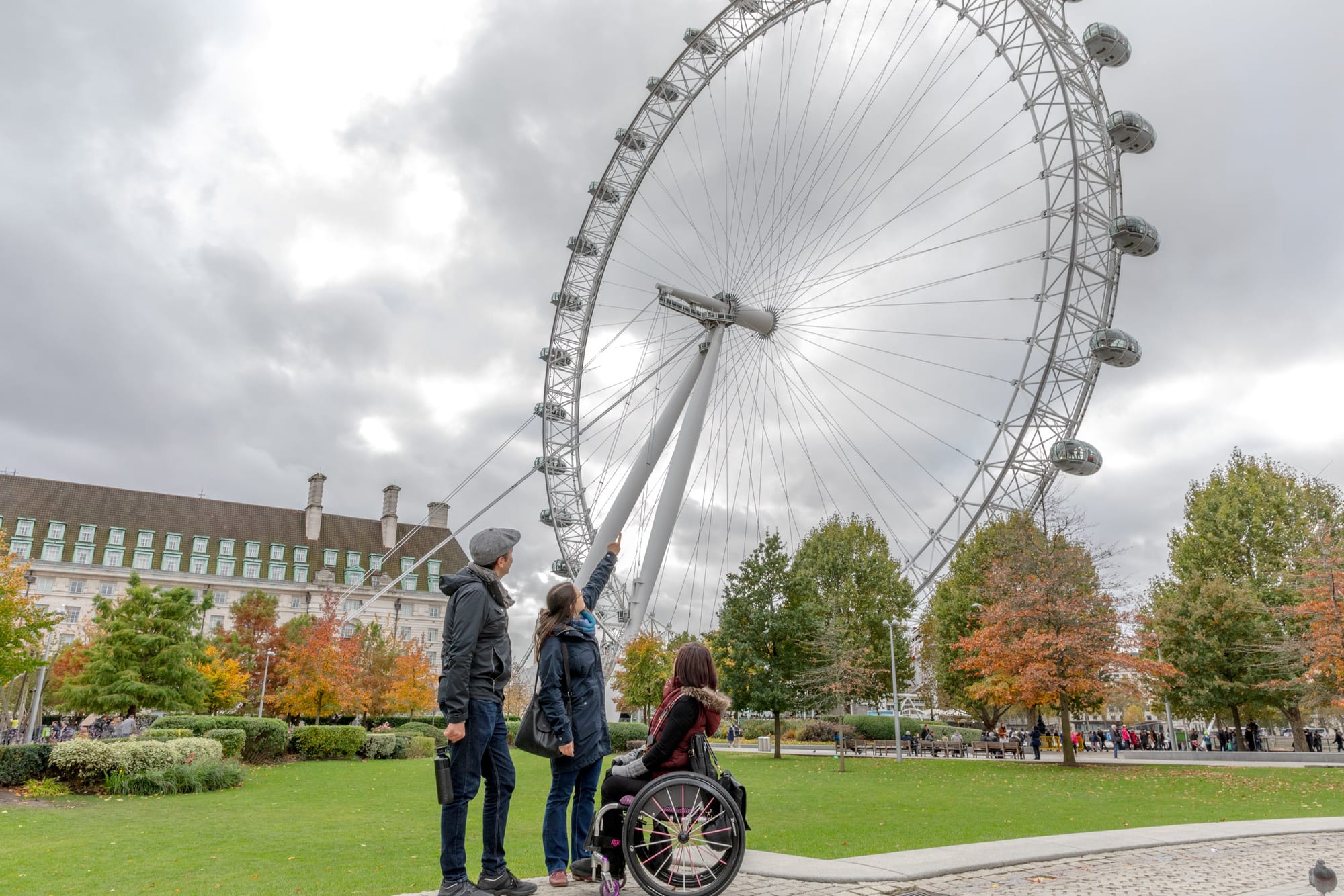 Wheelchair user looking up at the London Eye 