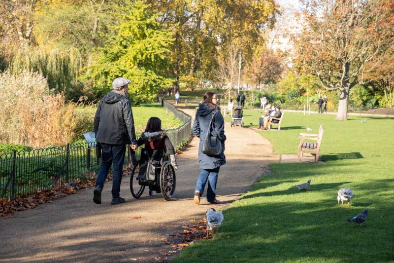 Wheelchair user exploring accessible paths in St Jame's Park in London, UK