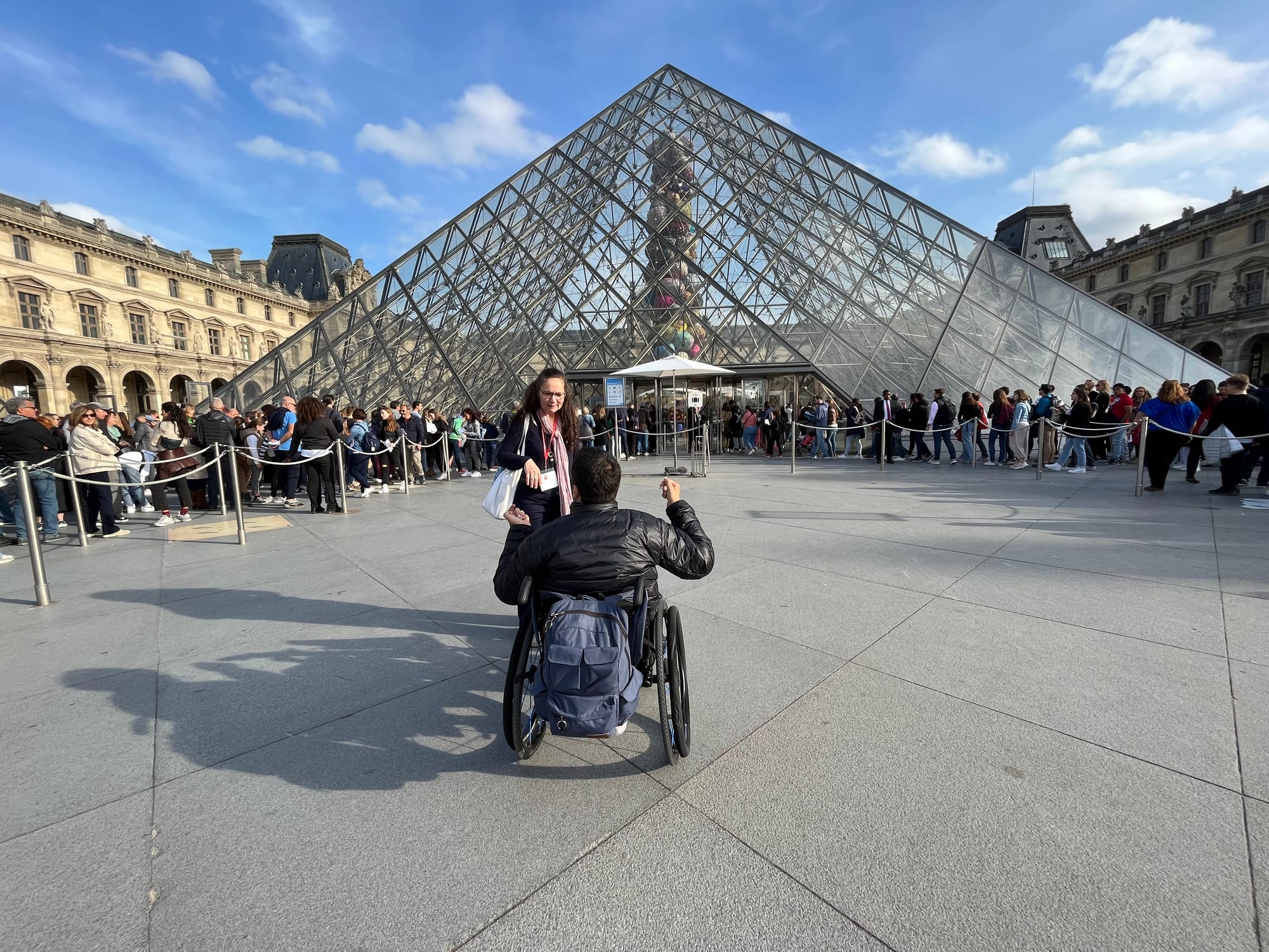 Wheelchair-user about to enter the Louvre Museum in Paris, France