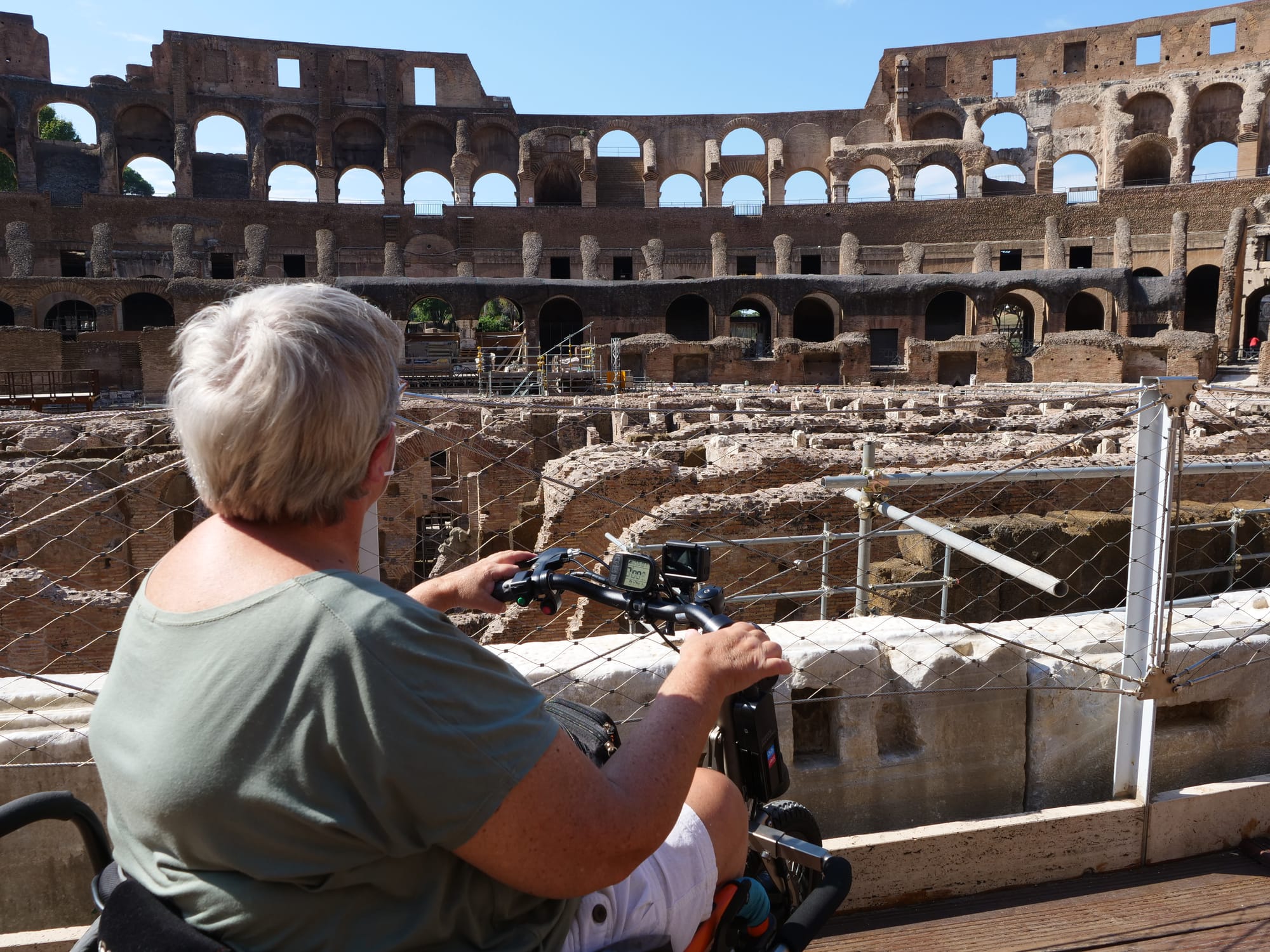 Wheelchair user viewing the Colosseum. An accessible attraction in Rome.