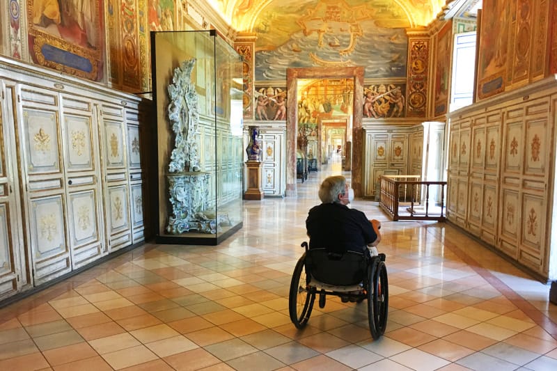 Wheelchair-user exploring a Vatican Museum in Rome, Italy