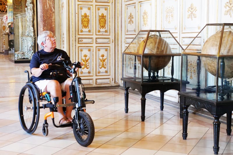 Wheelchair user exploring an accessible Vatican Museum in Vatican City.