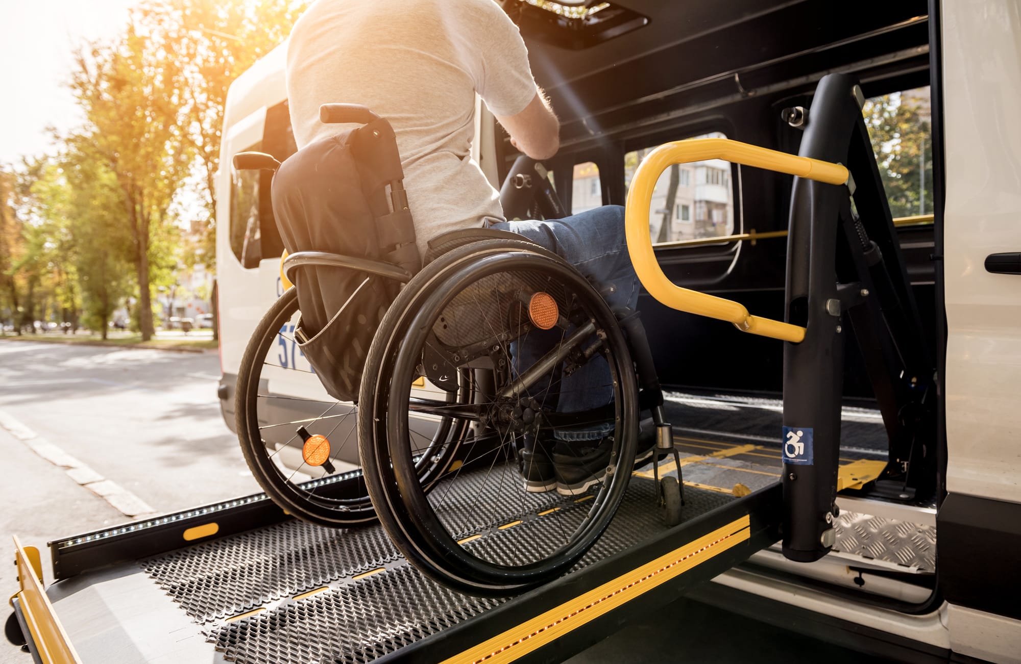 Wheelchair user getting in a van via accessible ramp