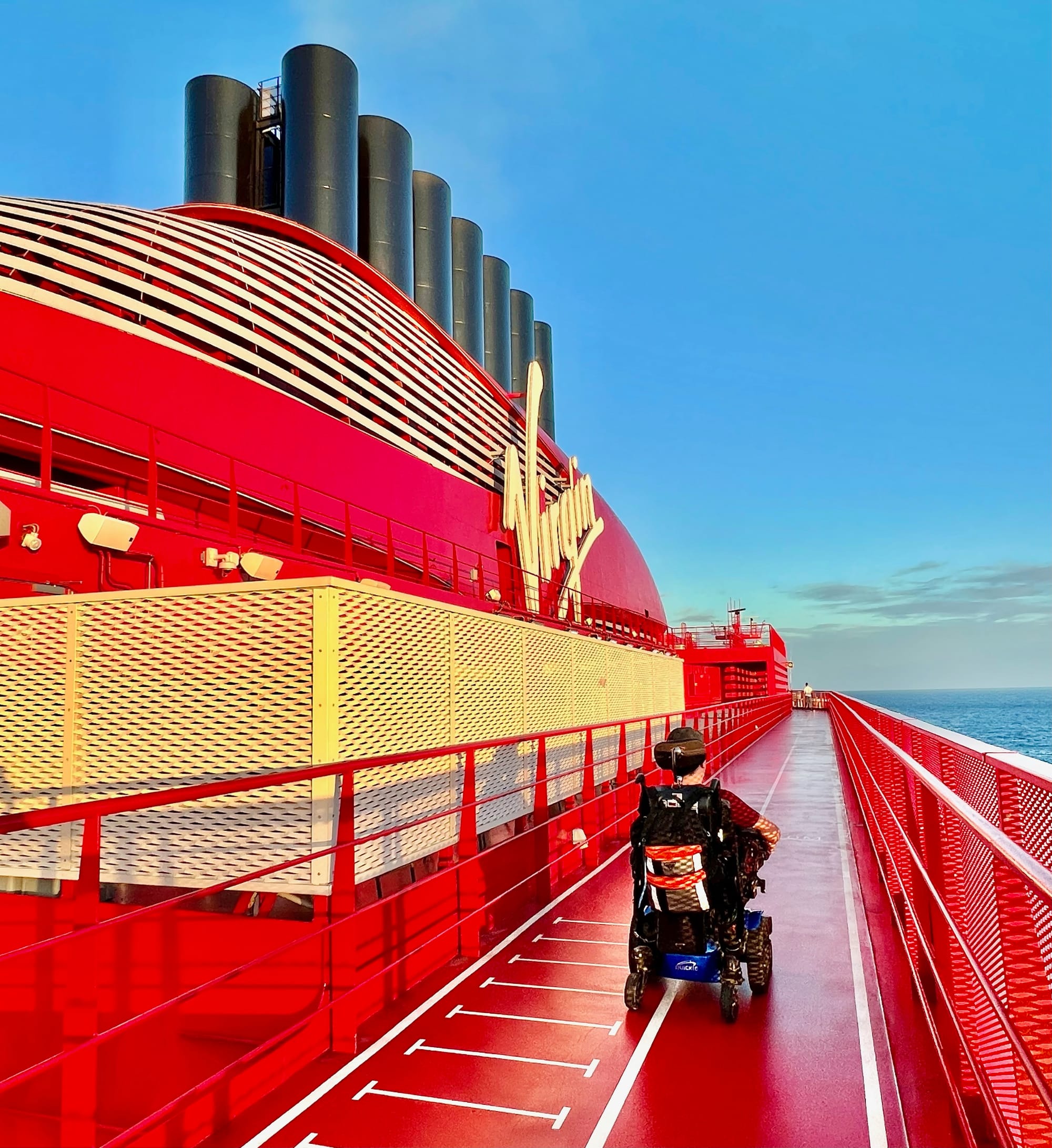Wheelchair-user exploring the cruise ship with ocean views