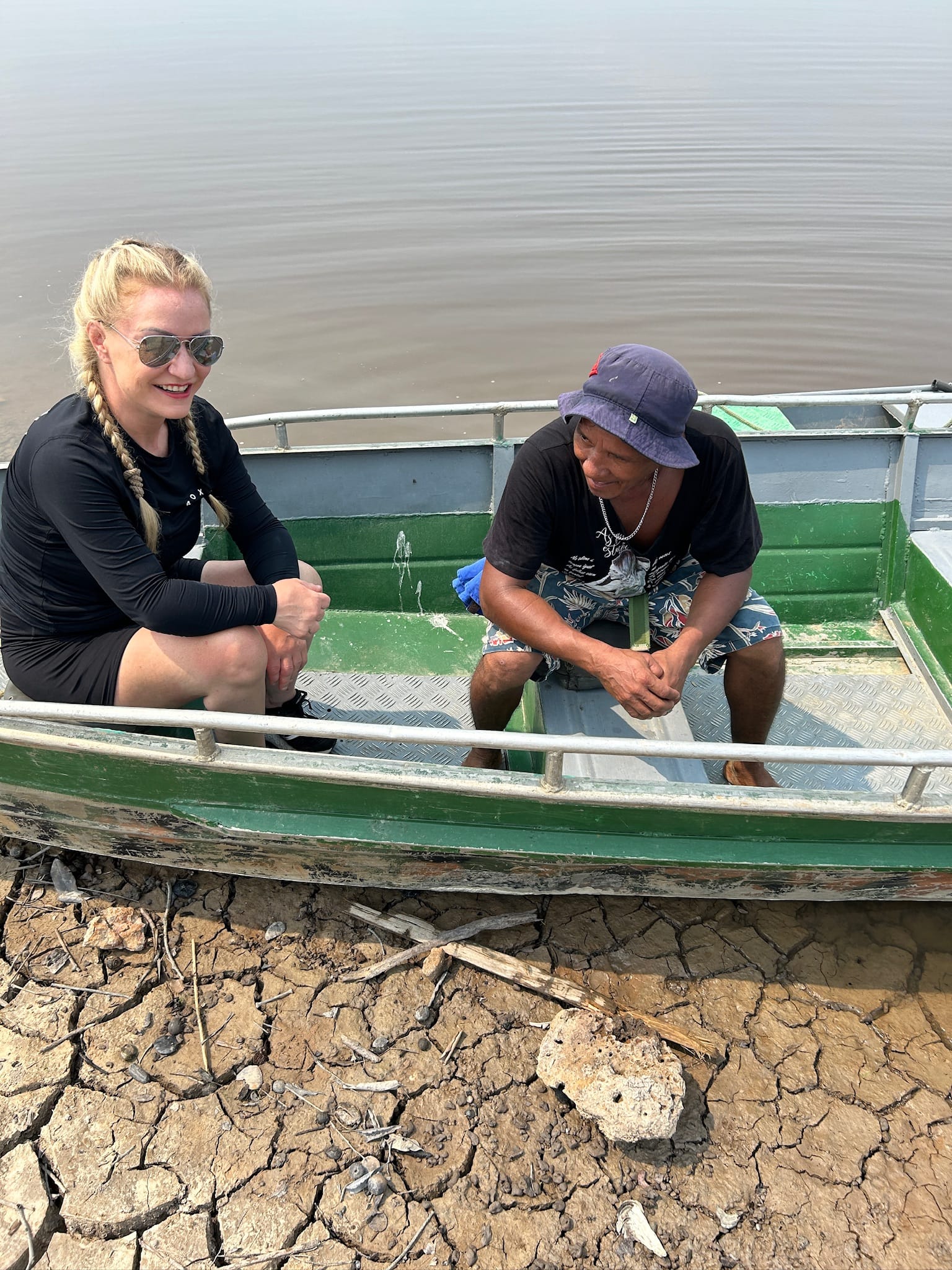Wheelchair-user on a boat with a local in the Amazon