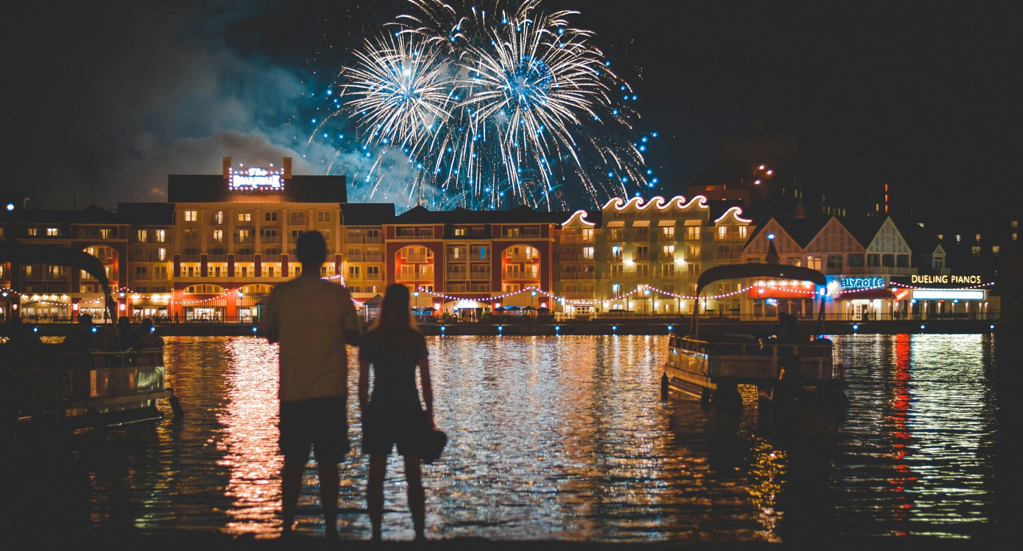 Boardwalk at Disney World with fireworks in background