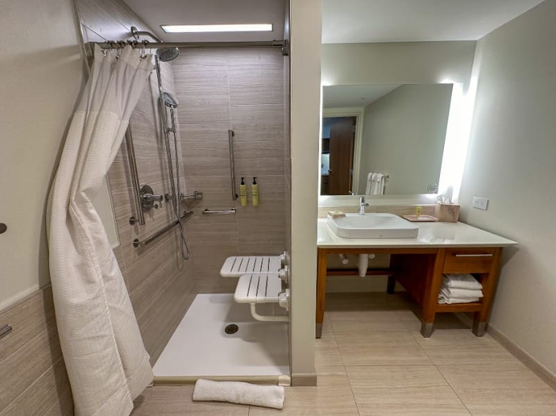 Roll-in shower with a shower seat and grab bars at Element Jacksonville Beach