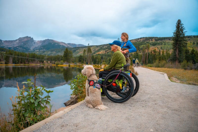 Wheelchair user fishing at a lake near Estes Park