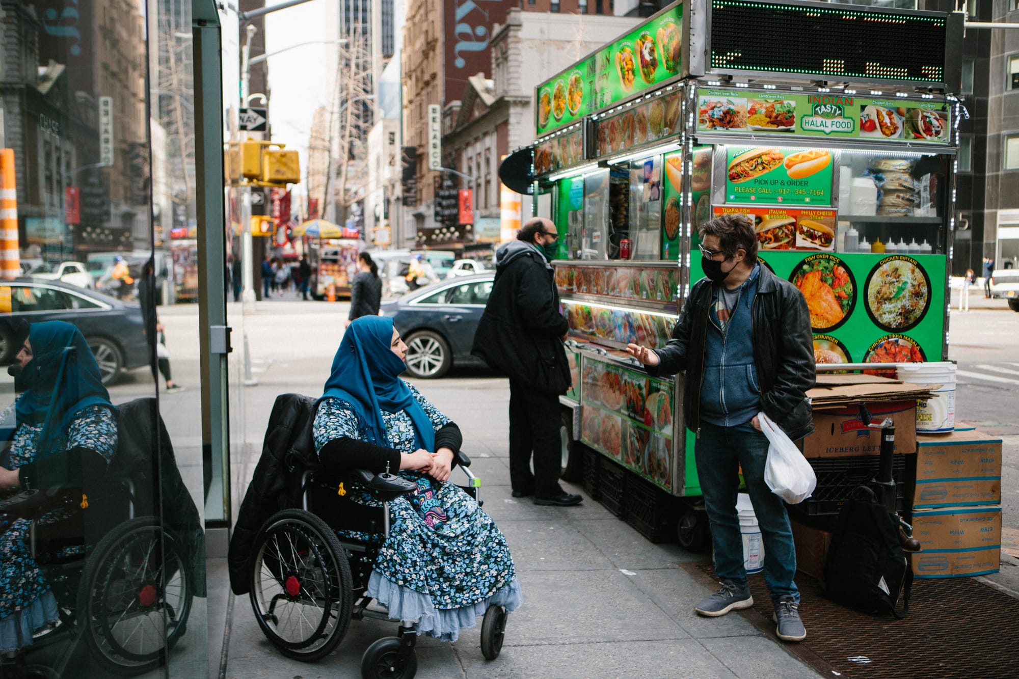 Wheelchair user in NYC chatting with a local