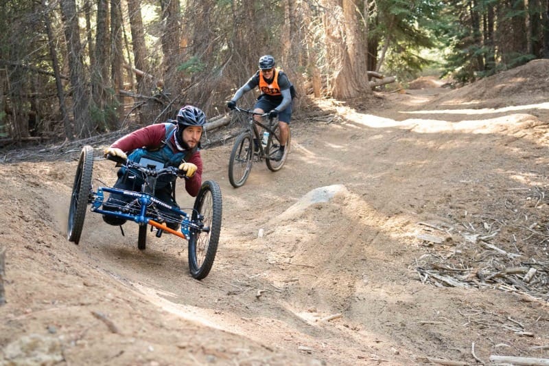 Wheelchair-user riding Central Oregon trail in an adaptive bicycle provided by Oregon Adaptive Sports