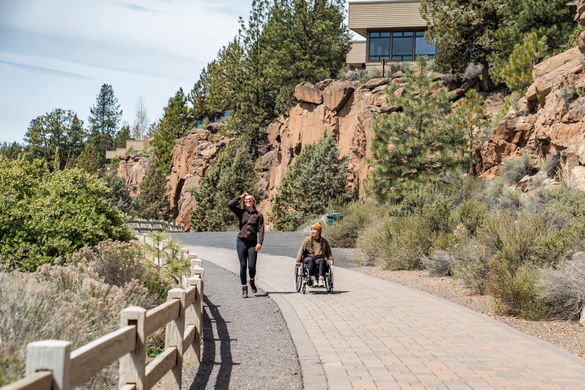 Wheelchair user rolling on accessible pathways at Riverbend South Access