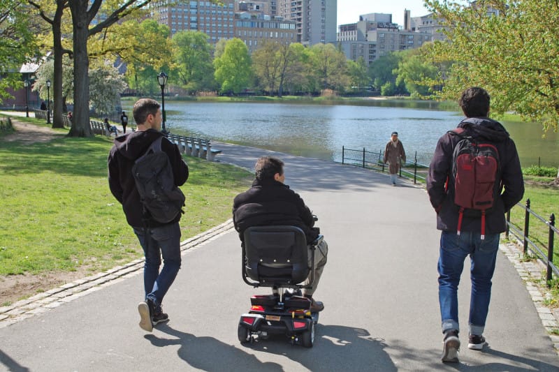 Wheelchair-user enjoying the accessible pathways at Central Park