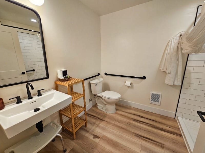 Spacious bathroom with wheelchair accessible roll-in shower at The Wildflower Inn in Gold Beach, Oregon