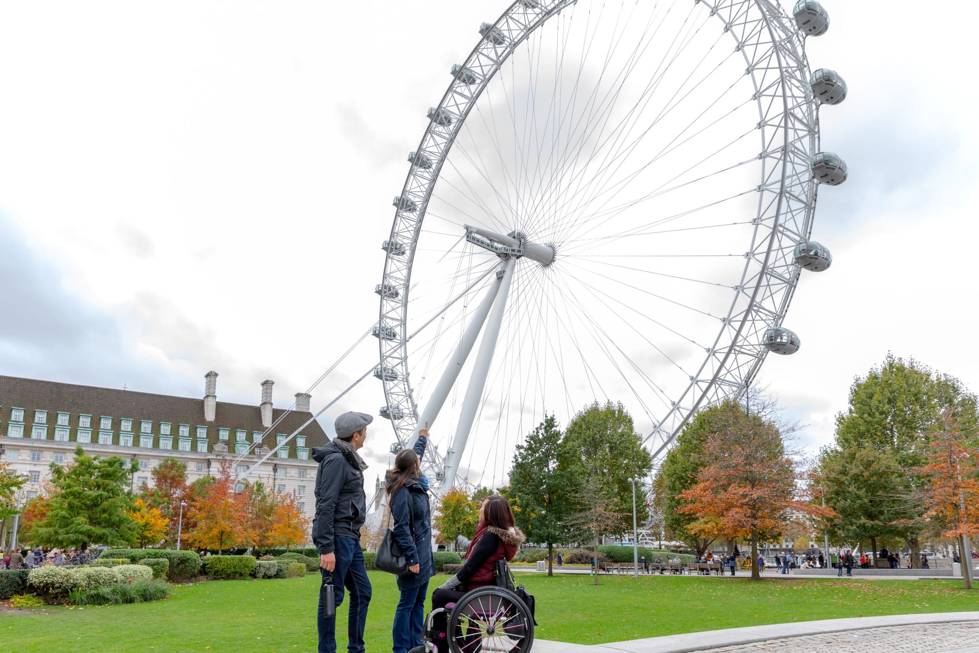 Wheelchair-user looking up at the London Eye, an accessible attraction in London