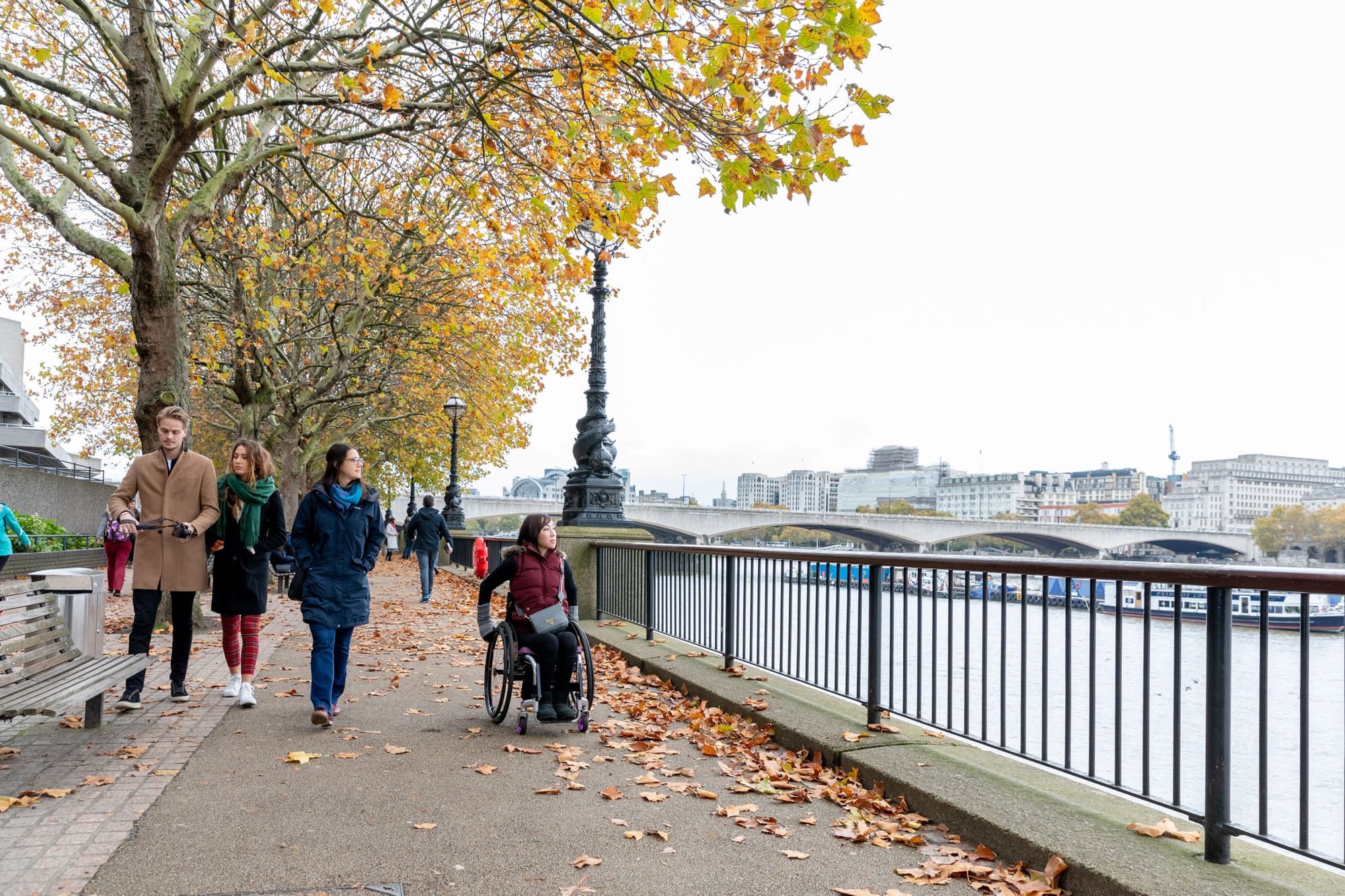 Wheelchair user on an accessible river trail in London