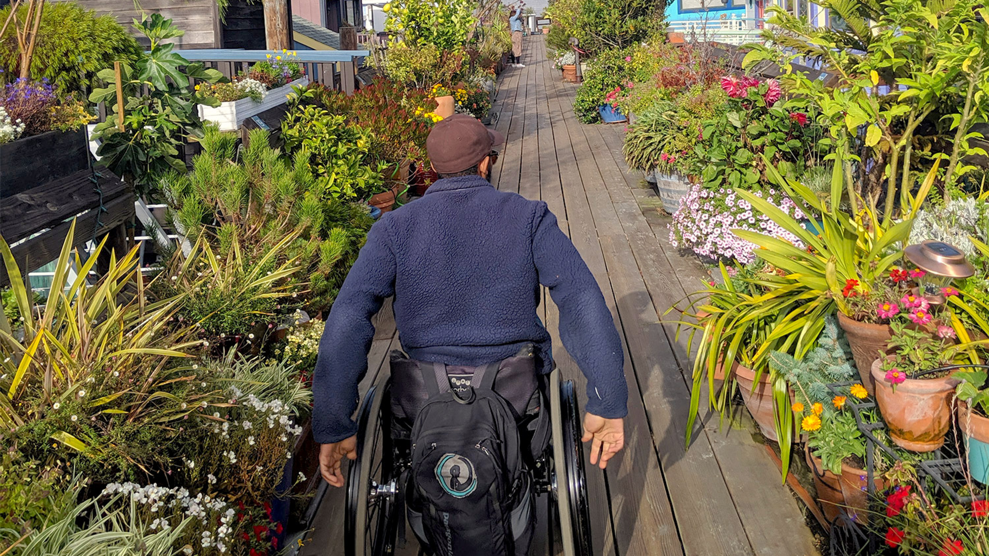 Wheelchair-user rolling on accessible walkway paths near San Francisco