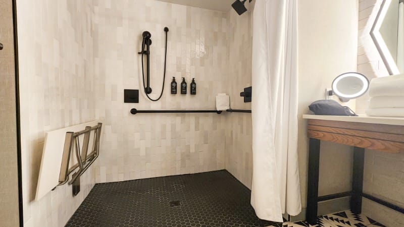 Roll-in shower, shower seat and grab bars at Senna House Hotel Scottsdale, Curio Collection by Hilton