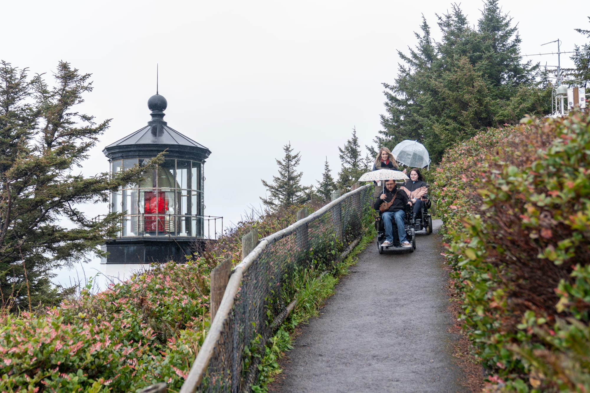 Wheelchair users going down the accessible paved trail at Cape Meares Lighthouse