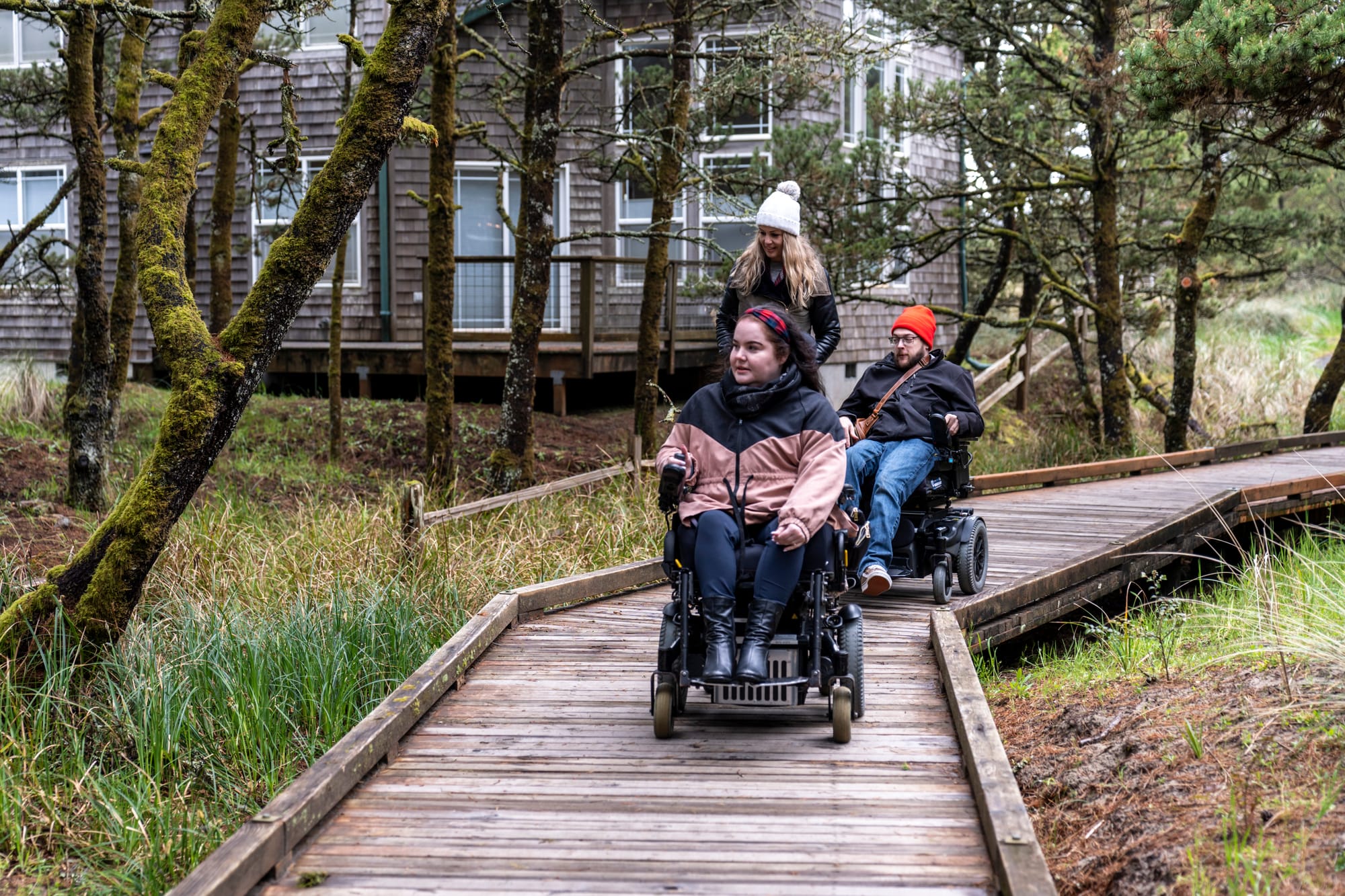 two wheelchair users exploring accessible pathways in Tillamook Coast