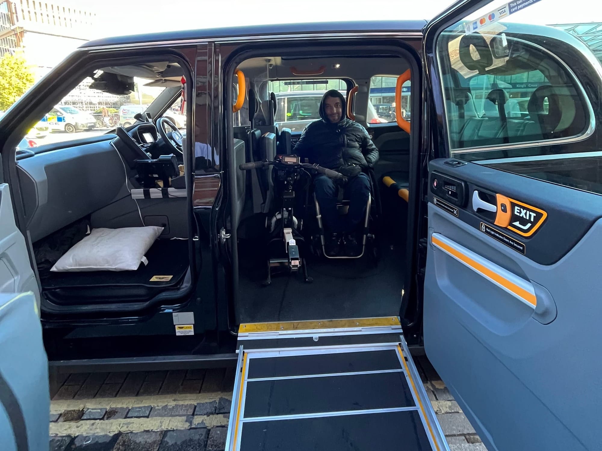 Wheelchair user in an adaptive van transfer via ramp in London