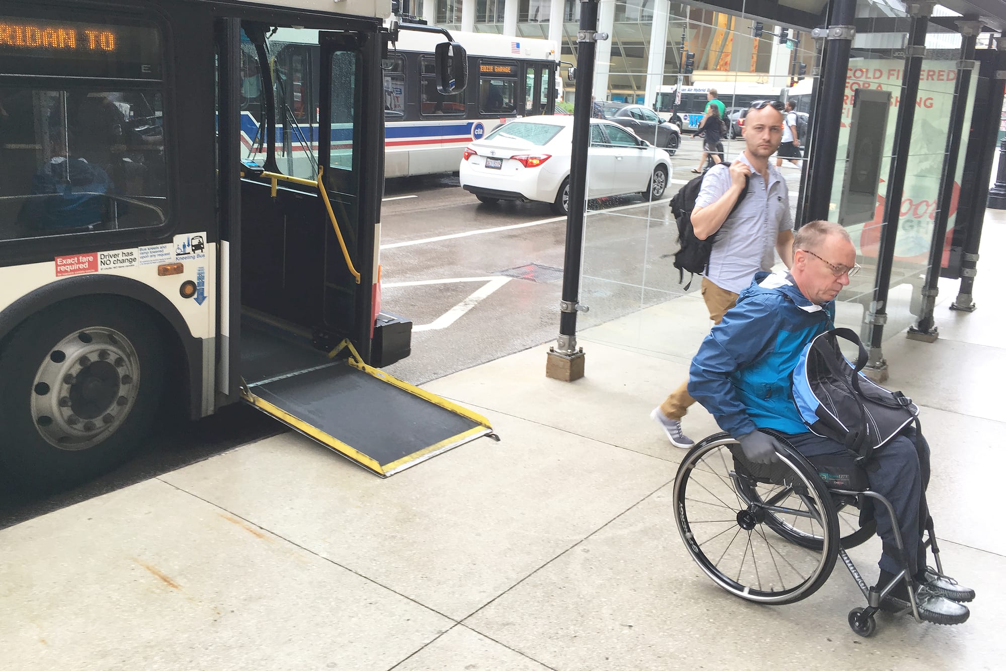 Wheelchair user gets off the accessible ramp at a Chicago bus station