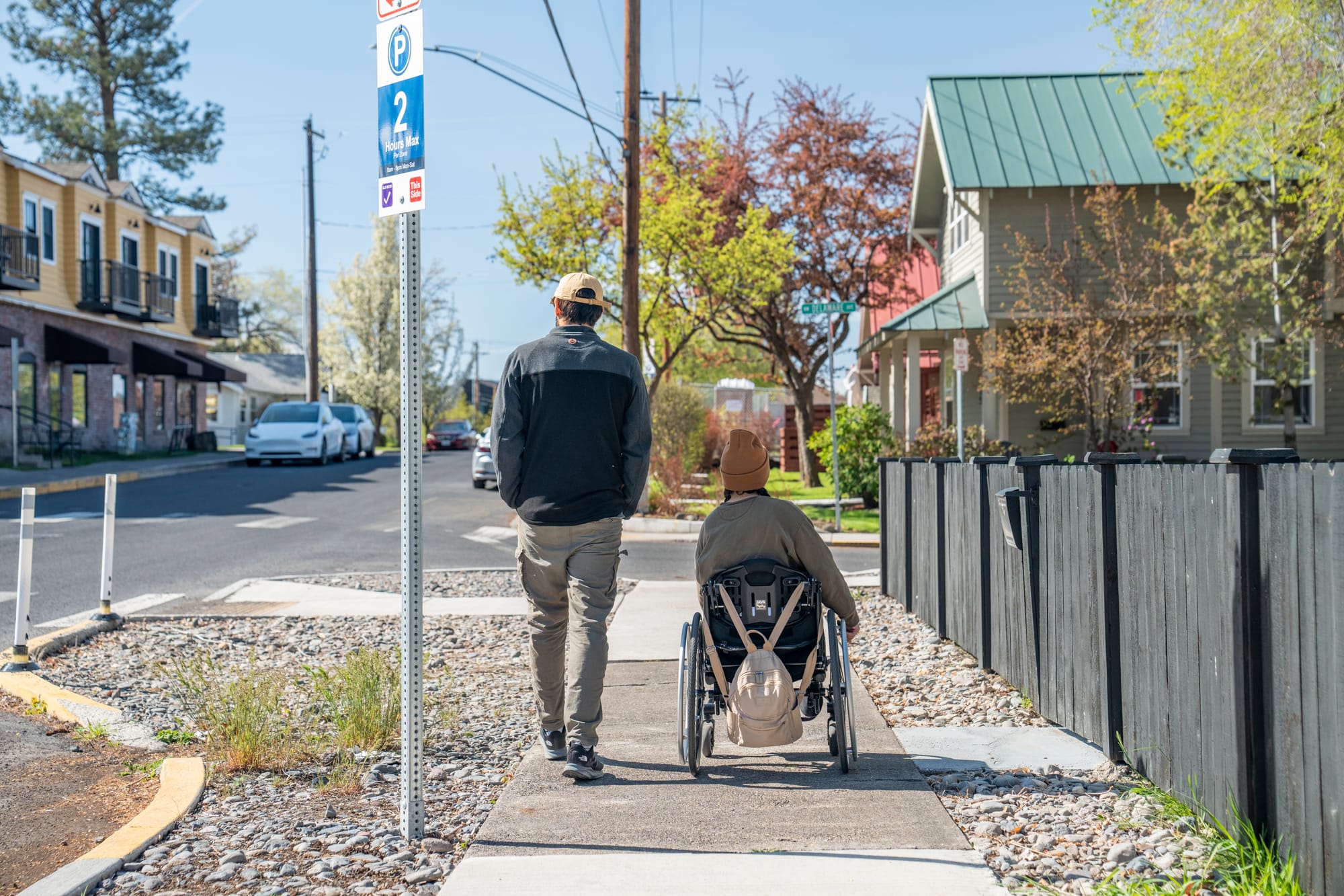 Wheelchair-user and companion exploring a Central Oregon town