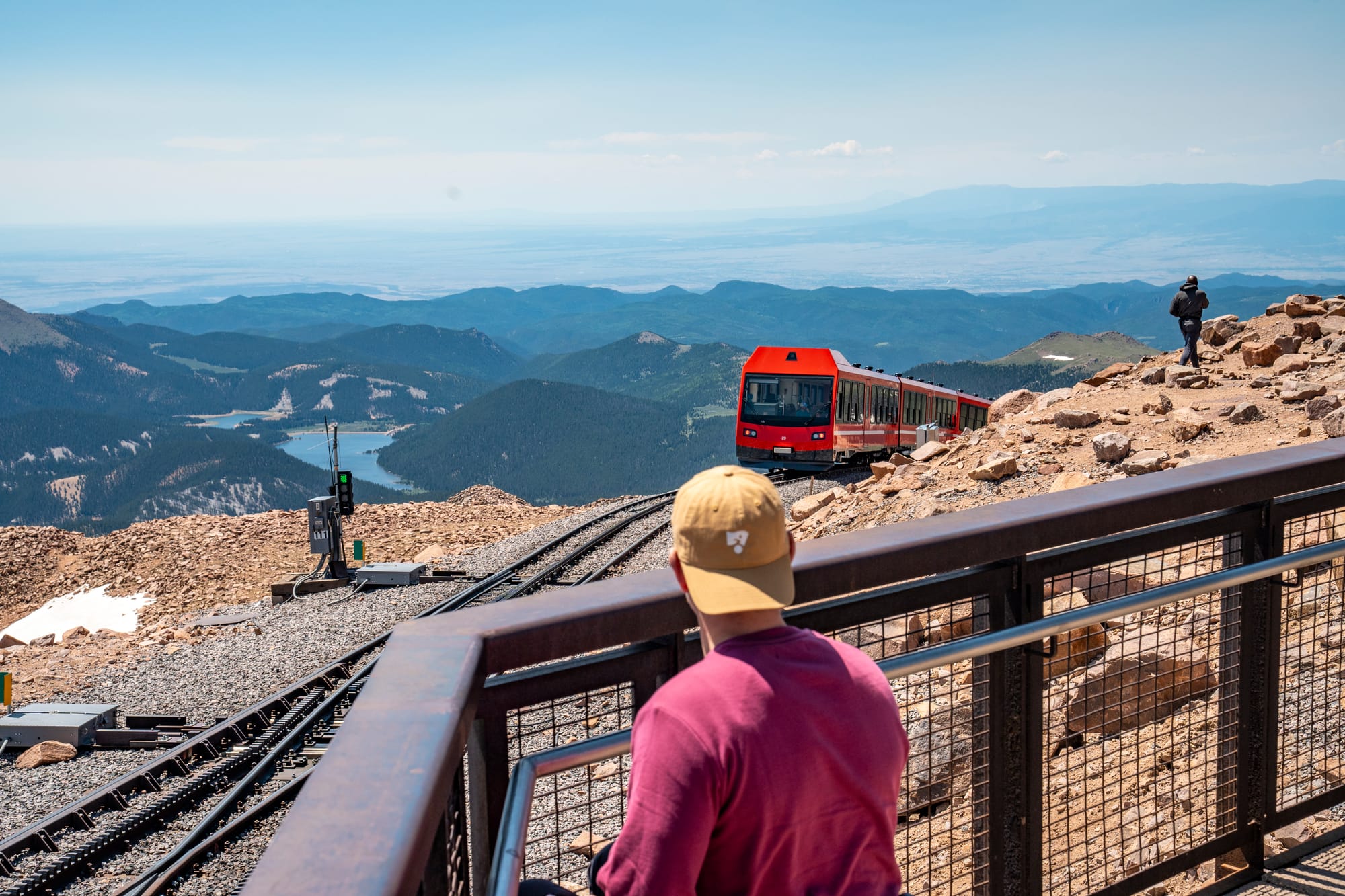 Wheelchair user overlooking Pikes Peak with railway in the background