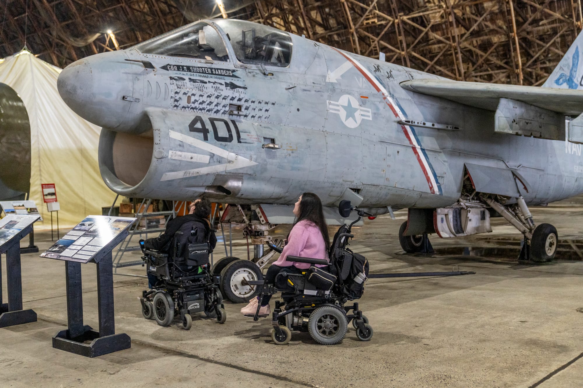 Two wheelchair users enjoying the Tillamook Air Museum, an accessible activity in Tillamook Coast