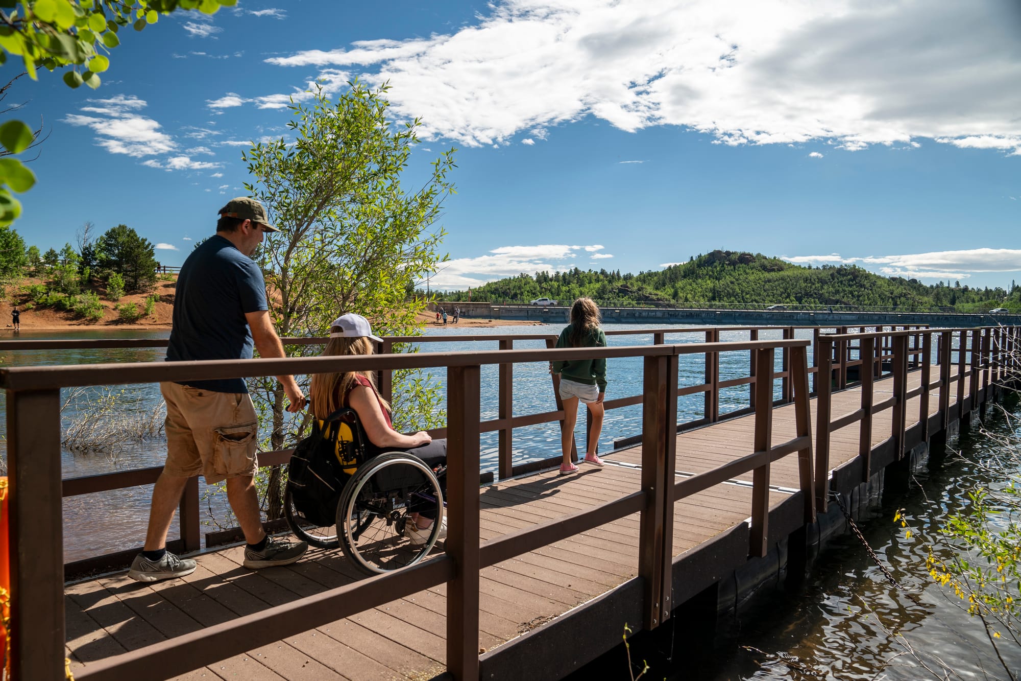 Wheelchair user rolling onto a lake dock in Colorado Springs