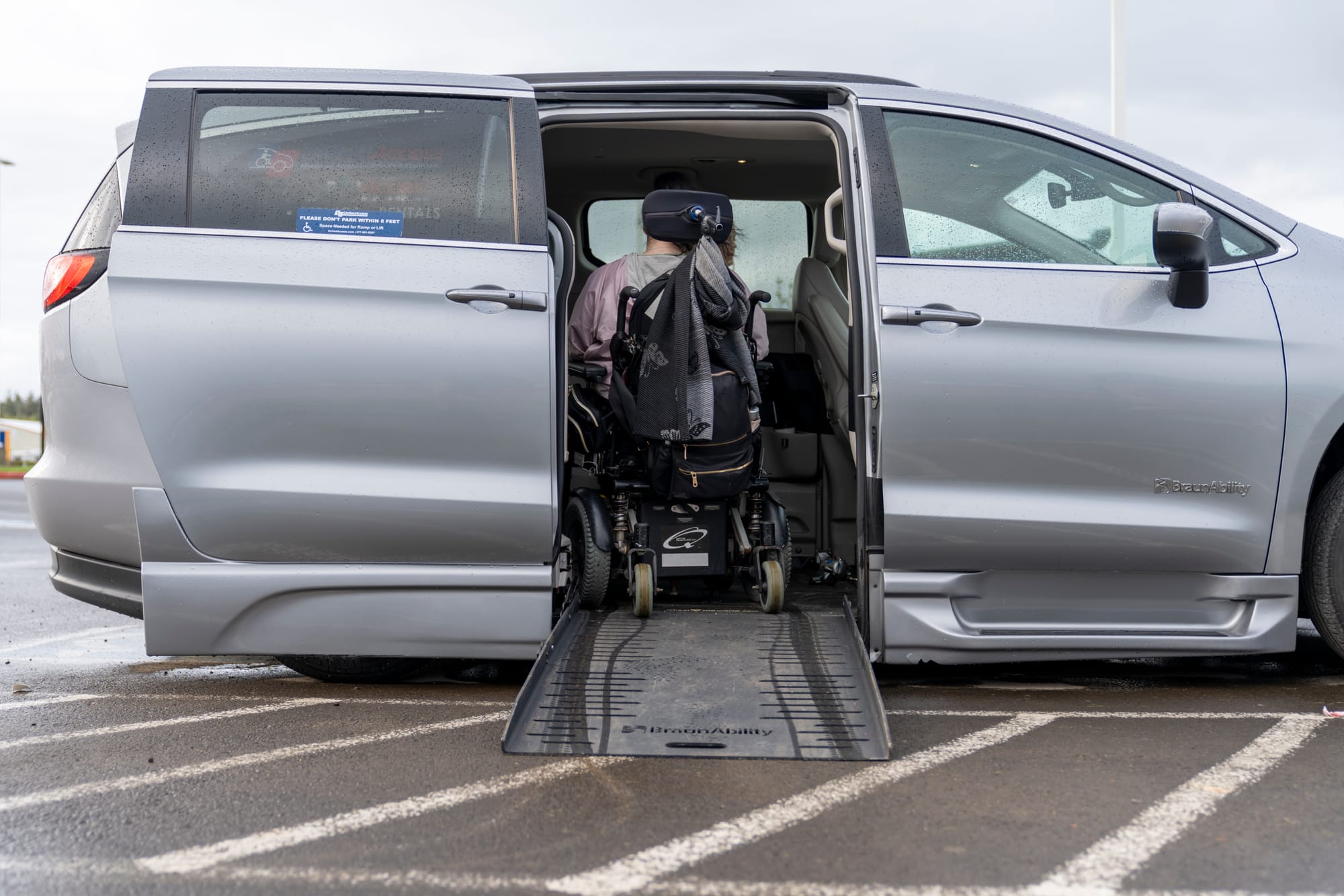 Wheelchair user going up ramp into adapted van