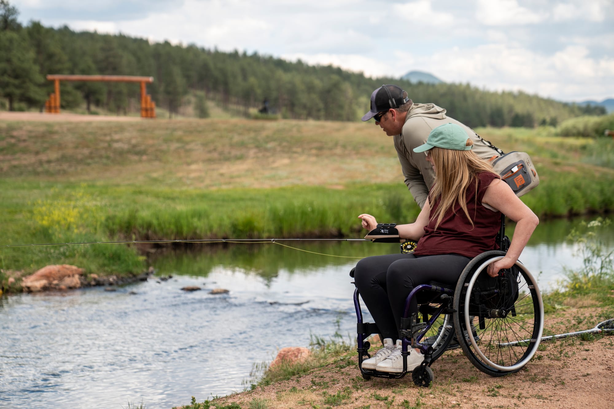 Wheelchair user trying adaptive fishing in Colorado Springs