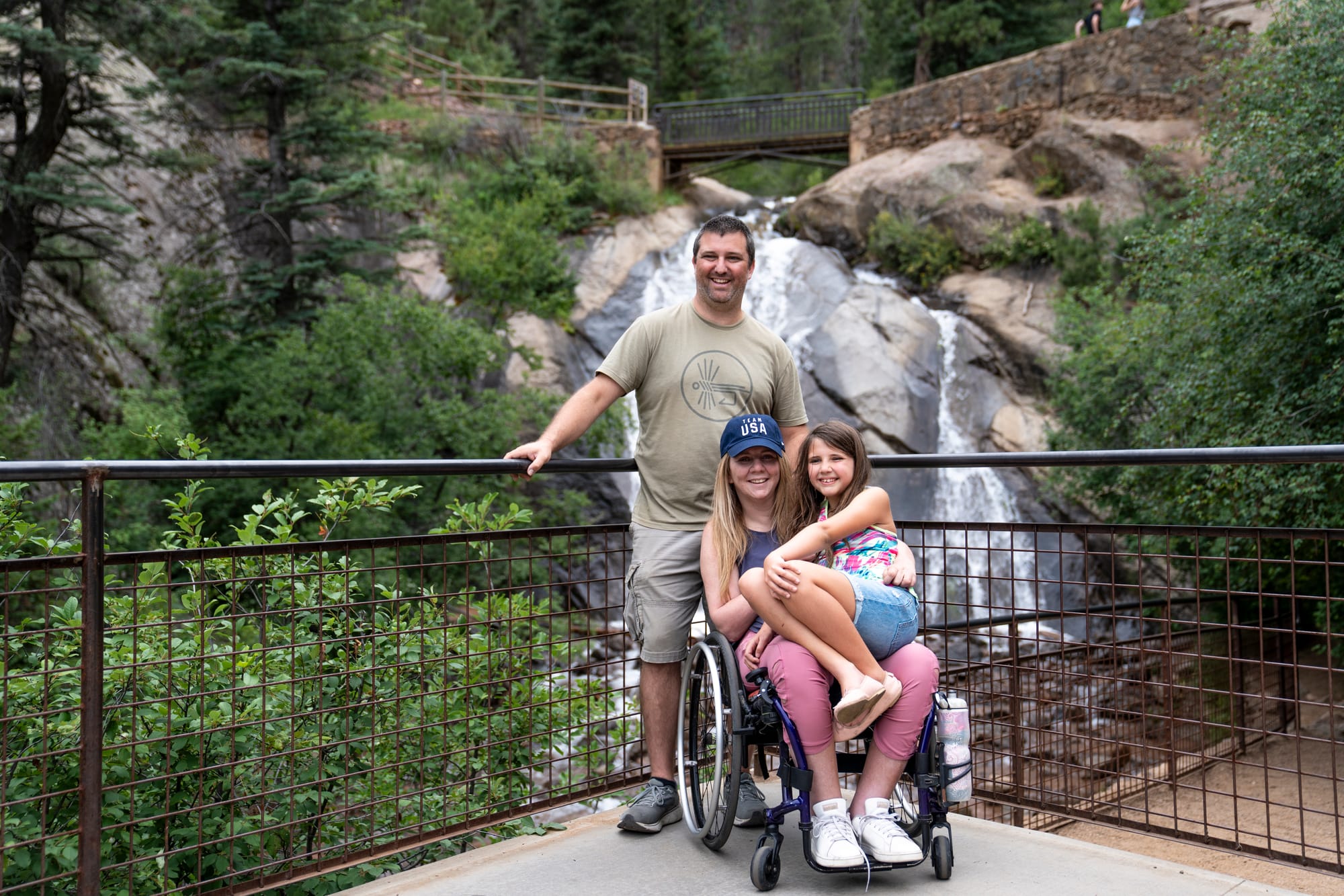 Wheelchair user and family enjoying a waterfall in Colorado Springs