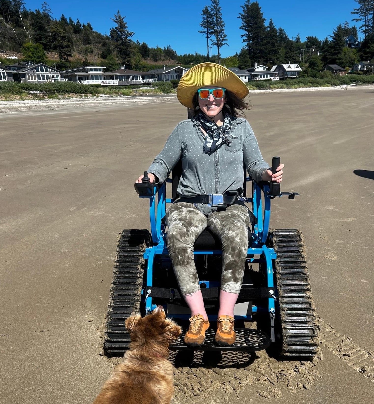 Wheelchair user exploring Manzanita Beach with a beach track wheelchair