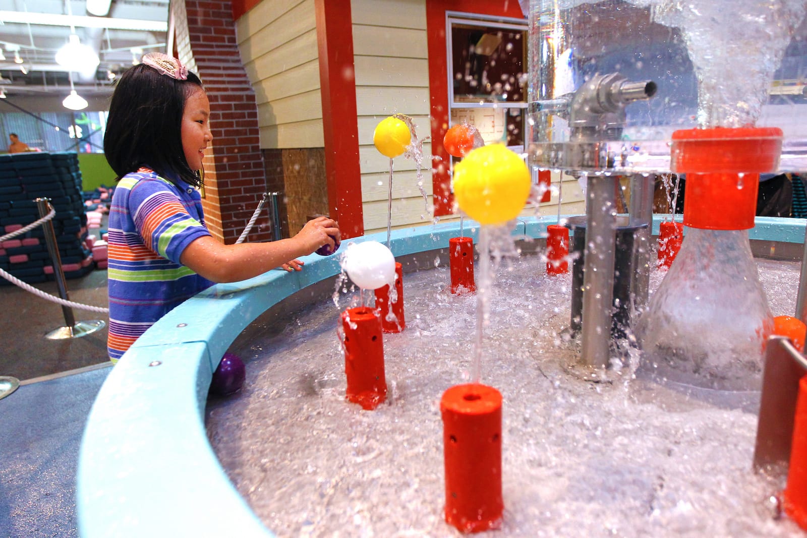 Child enjoying the interactive exhibits at Ann Arbor Hands-On Museum