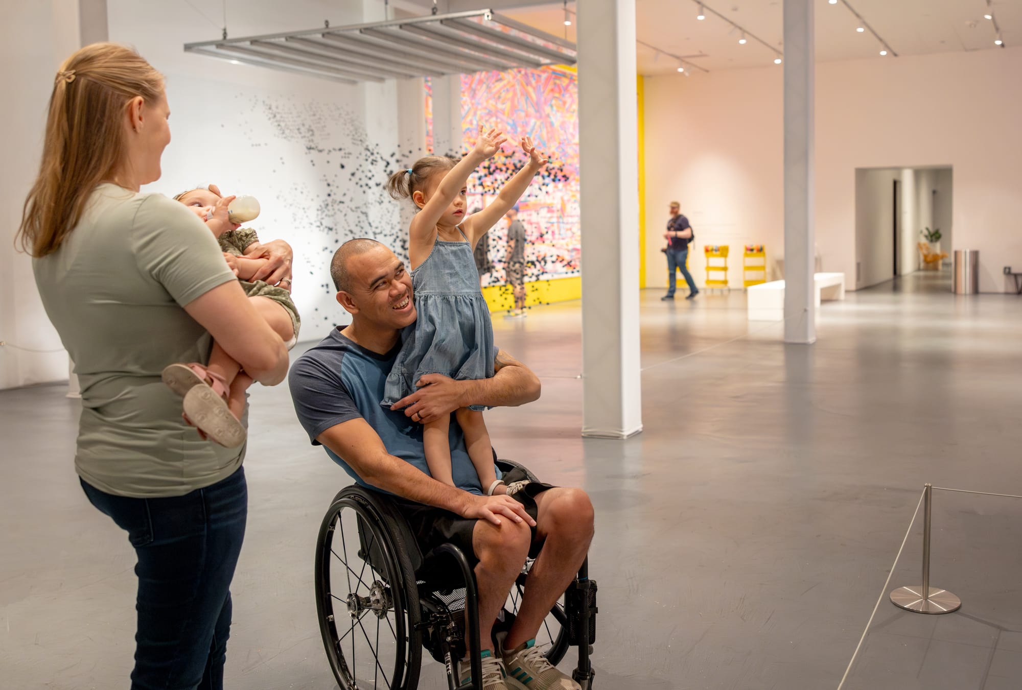 Wheelchair-user and family Exploring immersive art exhibitions at Wonderspaces Arizona in Scottsdale