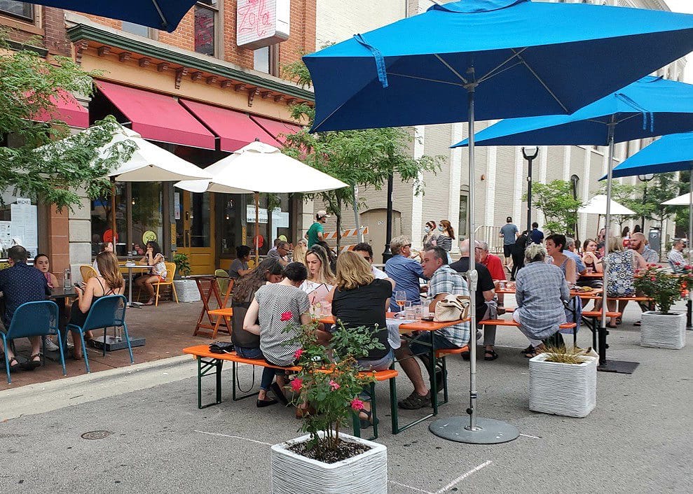 People dining outdoors in downtown Ann Arbor