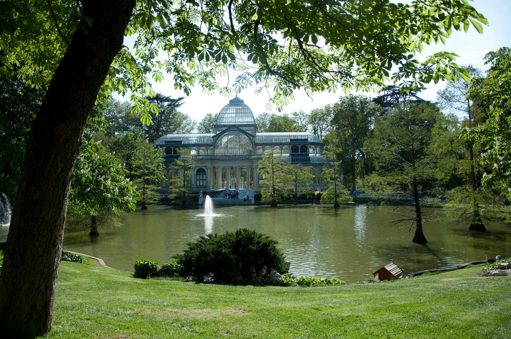 The Glass Palace behind a pond in Madrid, Spain