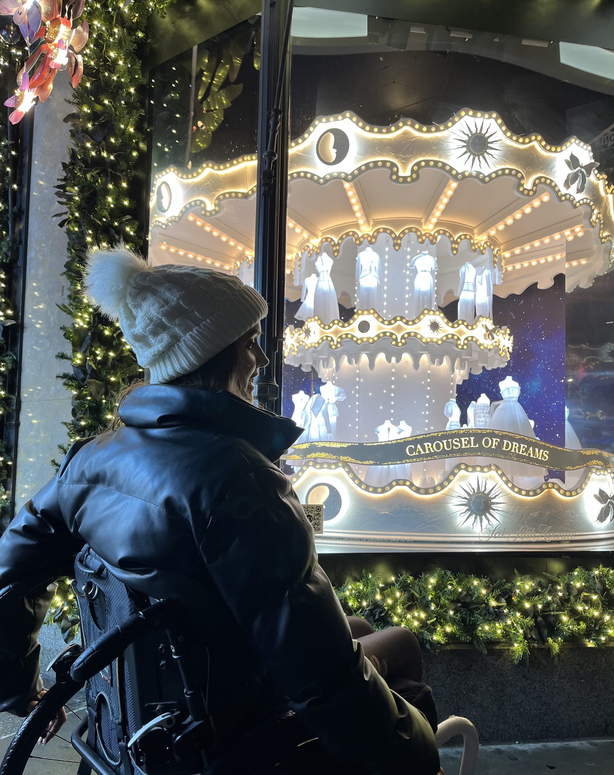 Wheelchair user enjoying window displays at Saks Fifth Avenue in NYC