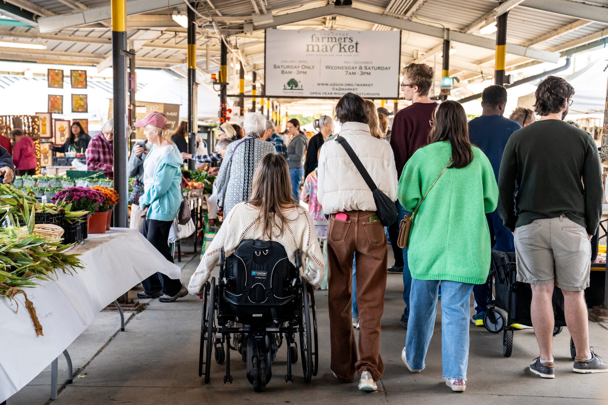 Wheelchair-user and friends at Kerrytown Farmers Market in Ann Arbor