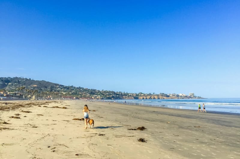 A girl walking on the beach in San Diego