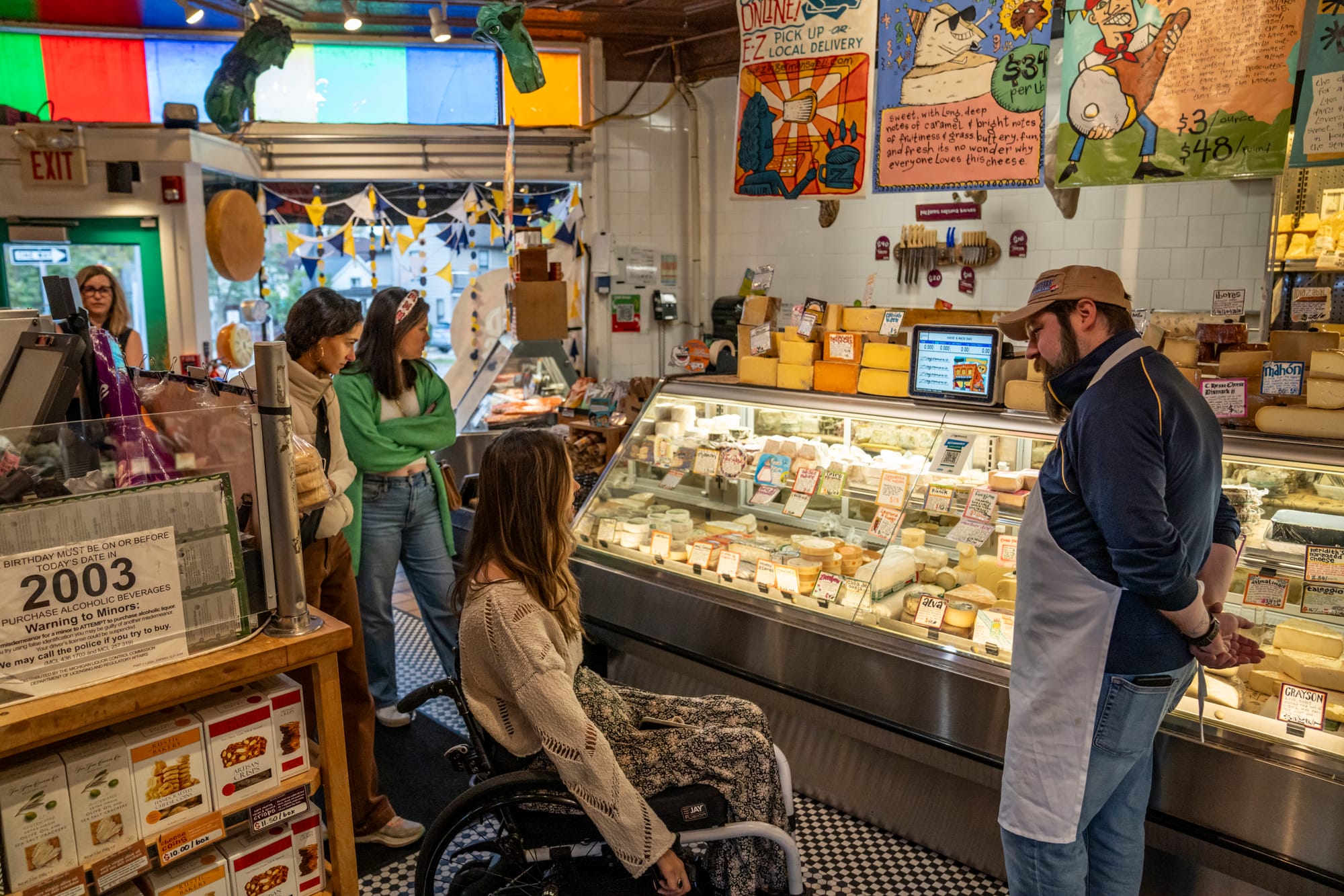 Wheelchair-user chatting with store employee at Zingerman's Deli