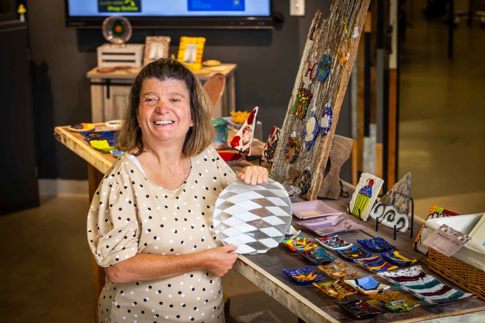 Lady showing off art at InsideOut Studio in Butler County