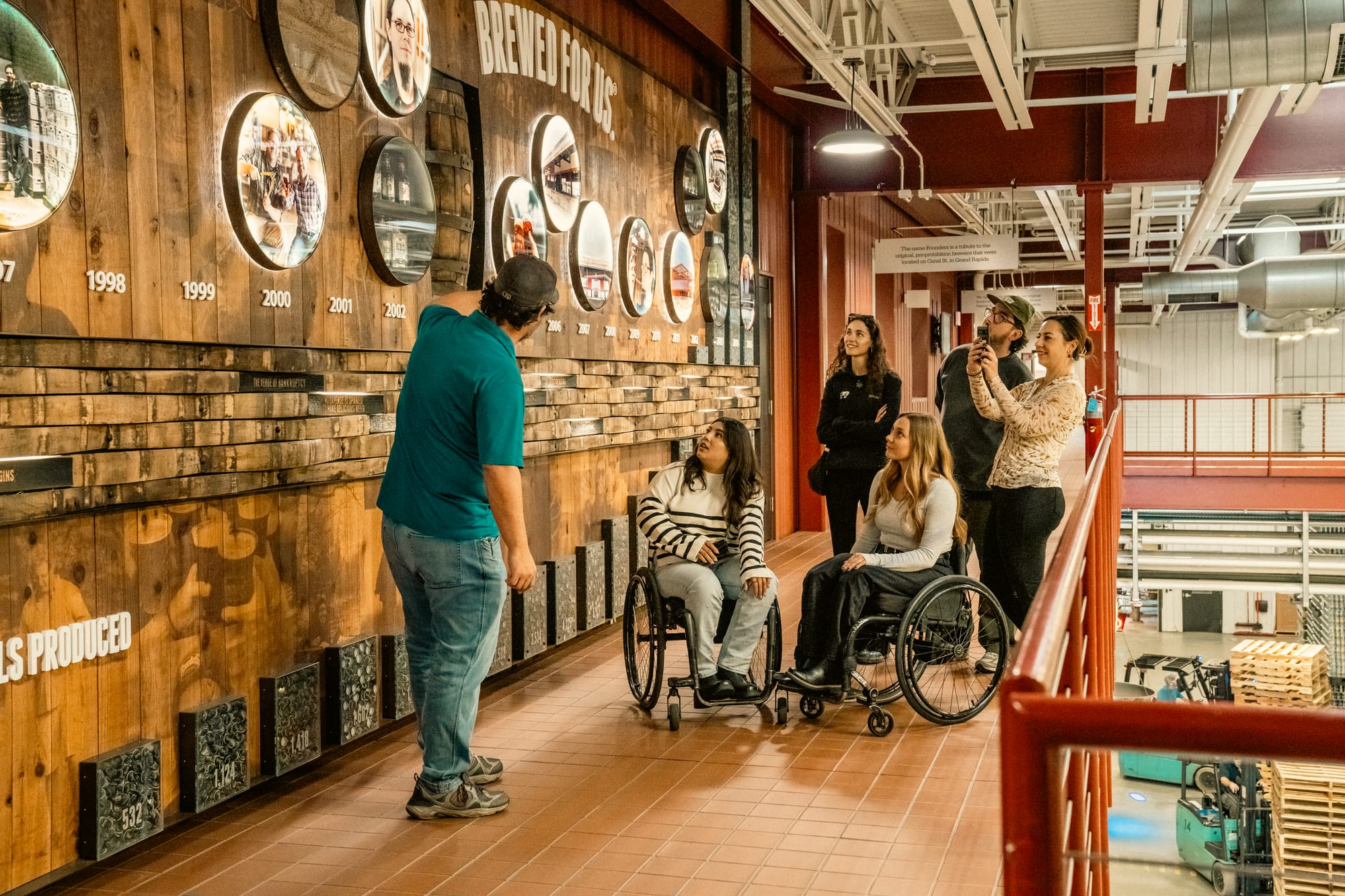 Wheelchair-users and others on an accessible tour of Founders Brewing Company