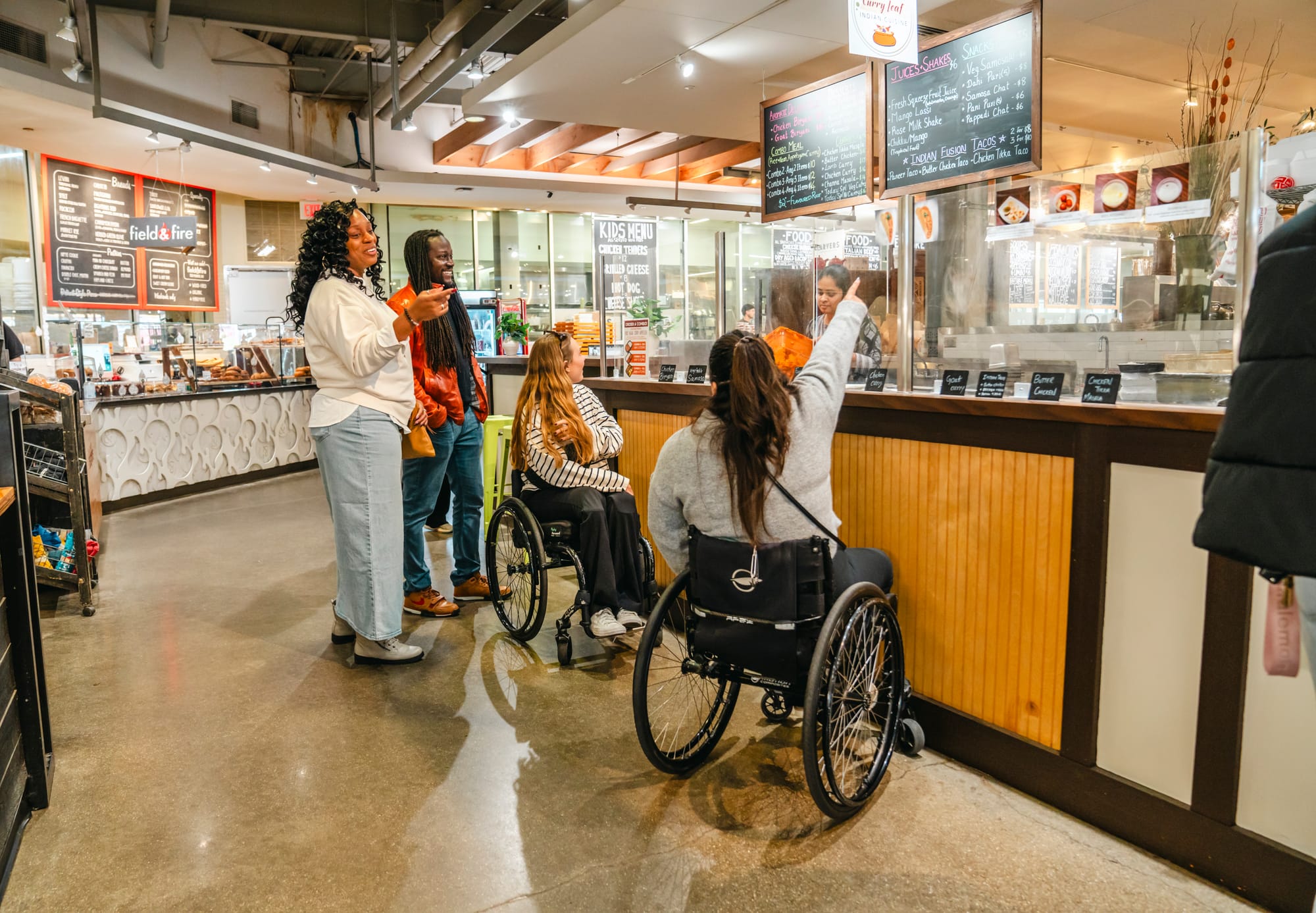 Wheelchair-users grabbing dessert at the Downtown Market